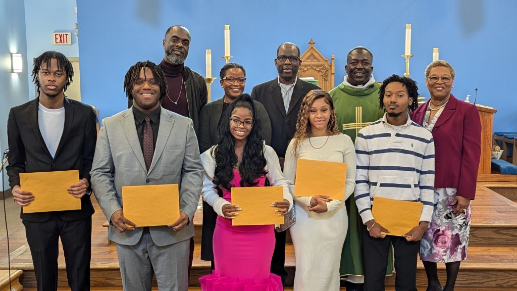 nativity scholarship recipients with envelopes in church