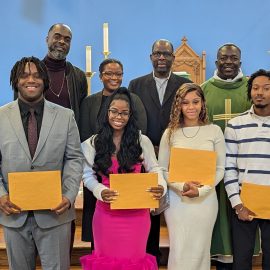 nativity scholarship recipients with envelopes in church